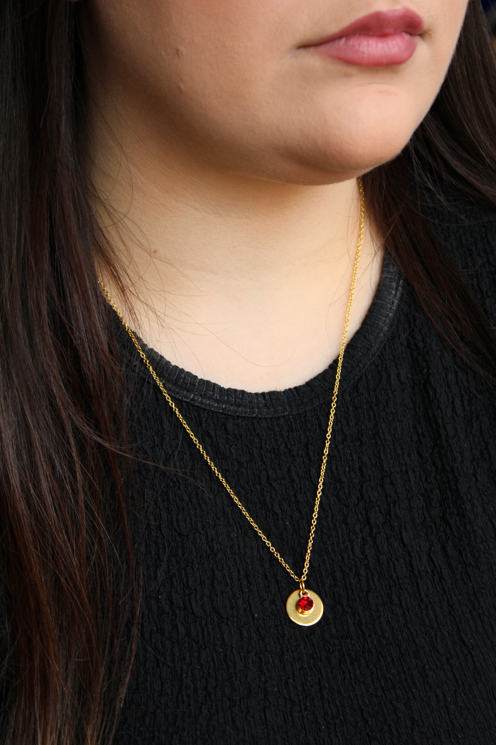 Model wearing Allie Bee coin and gem necklace in red