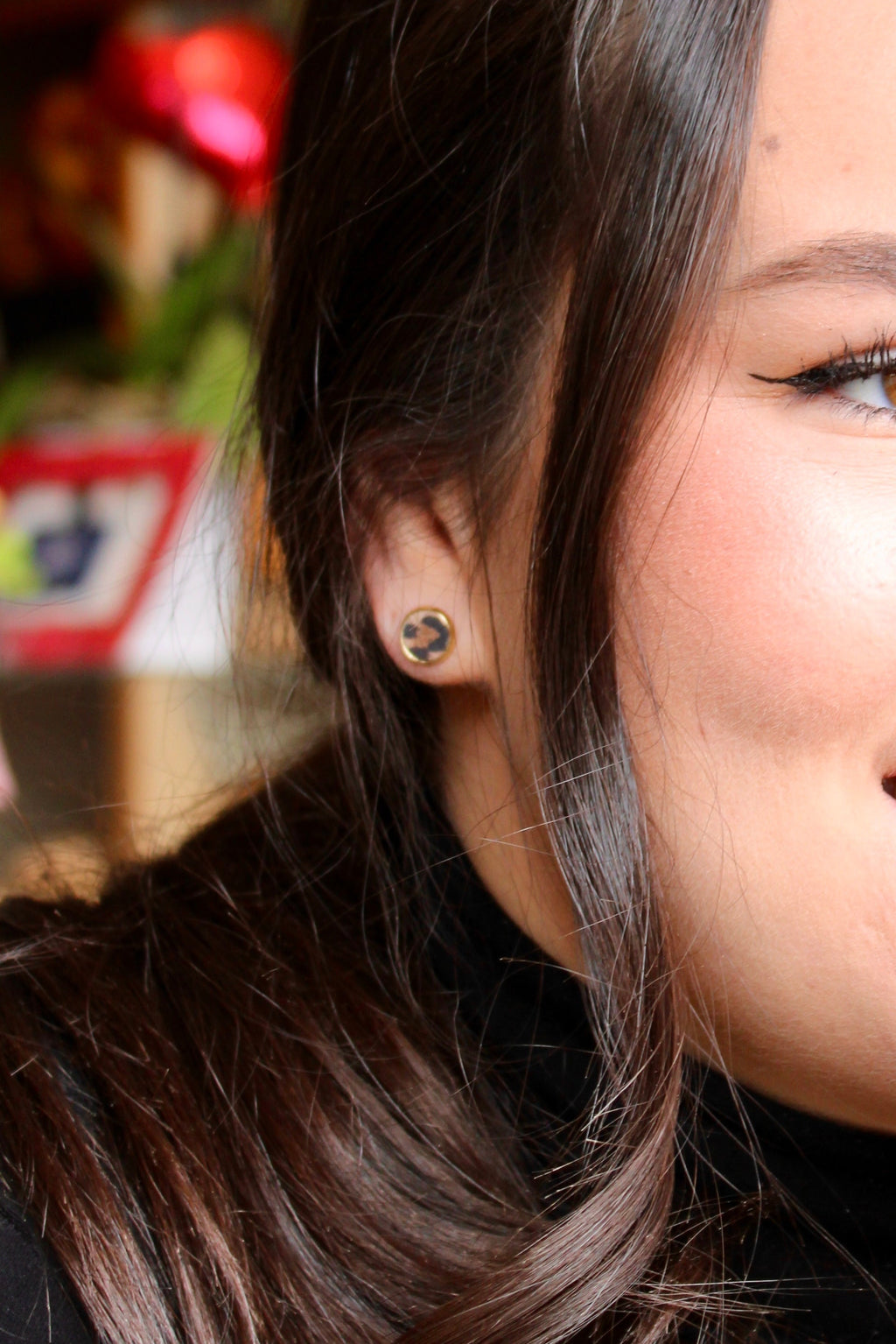 Model wearing Hazy Bee leather stud earrings in leopard