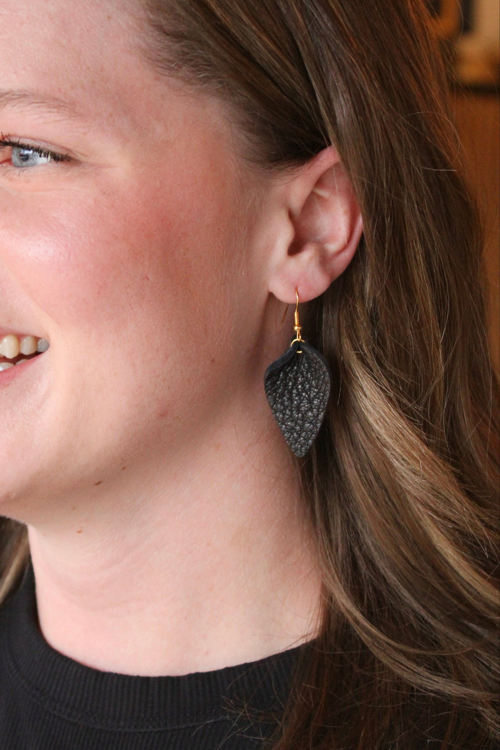 Model wearing Jaimie Bee leather petal earrings in black