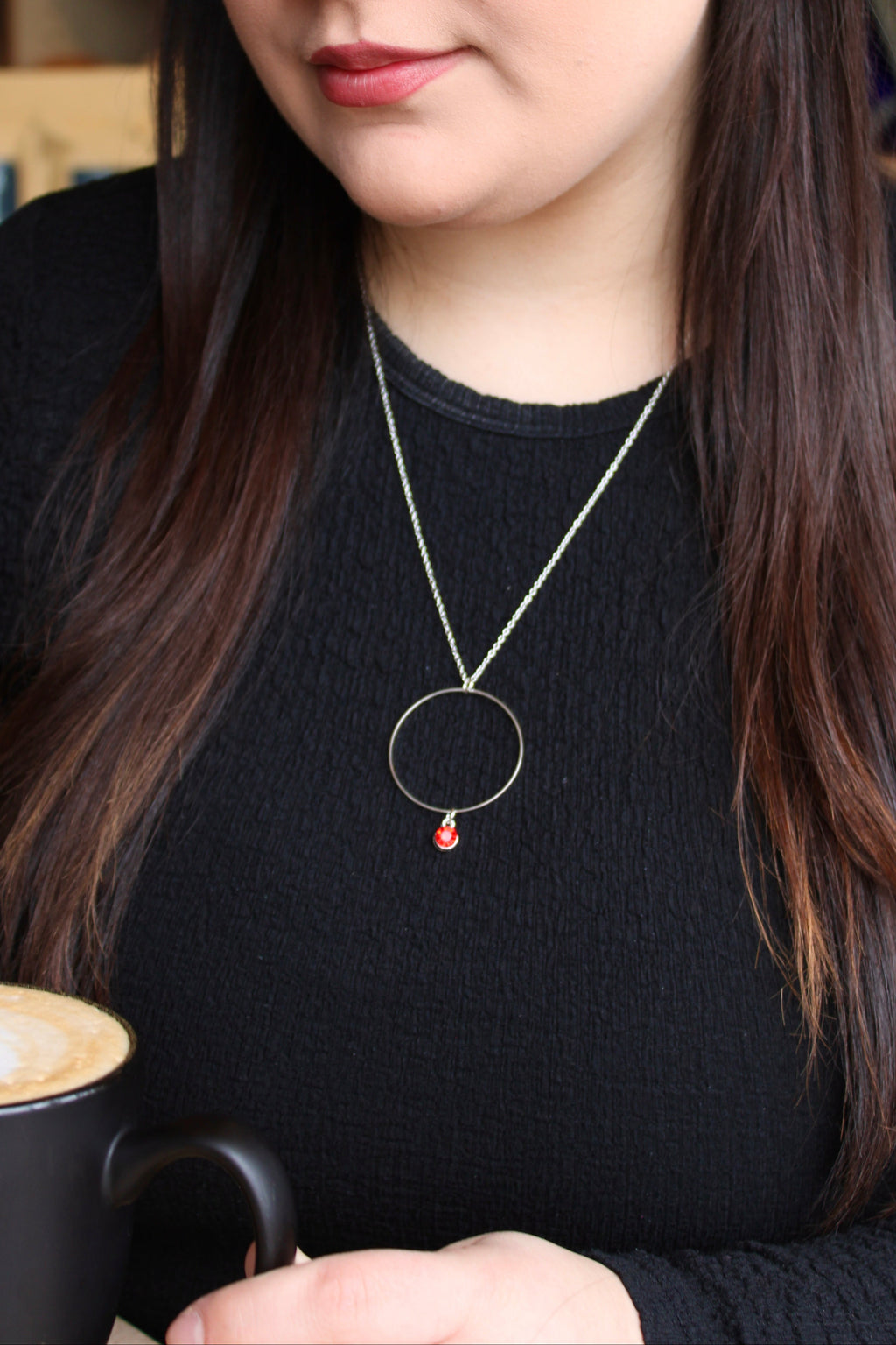 Model wearing Sophie Bee hoop and gem necklace in red
